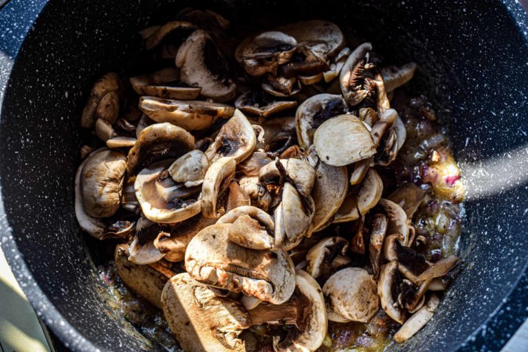 adding sliced mushrooms