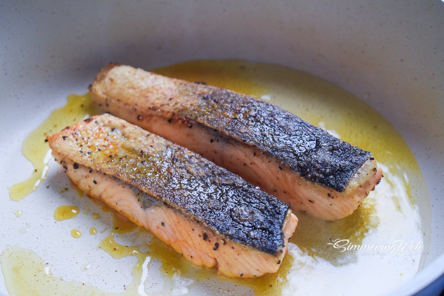 Crispy skin salmon searing skin-side down in a non-stick pan until golden brown